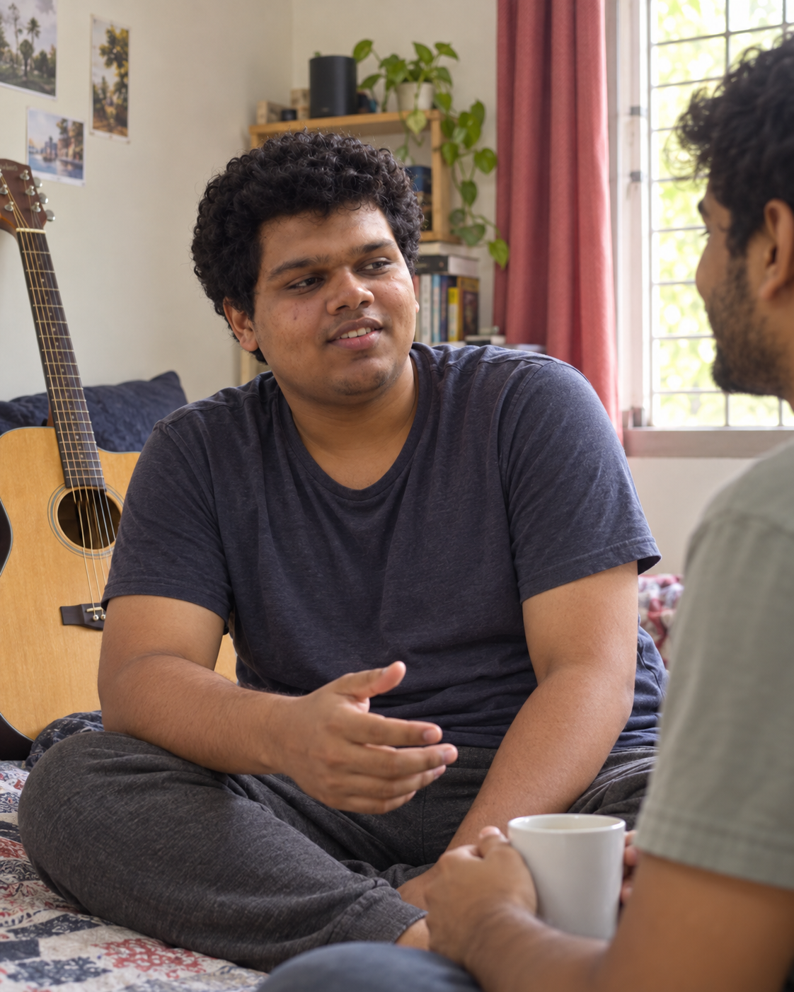 Conceptual candid-style portrait of recording artist Yethikrishna R in an informal conversation in a music setting.